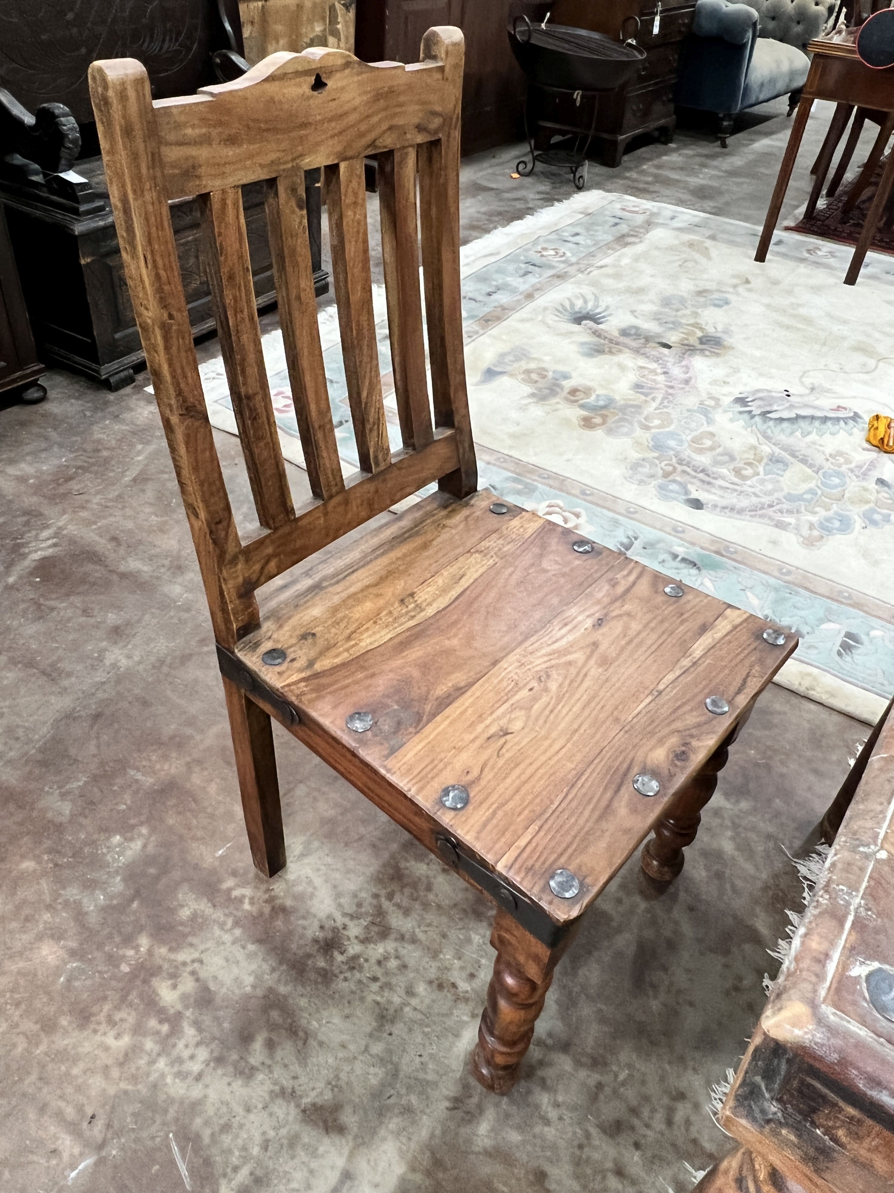 An Indonesian rectangular studded hardwood dining table, length 180cm, depth 90cm, height 76cm and two chairs